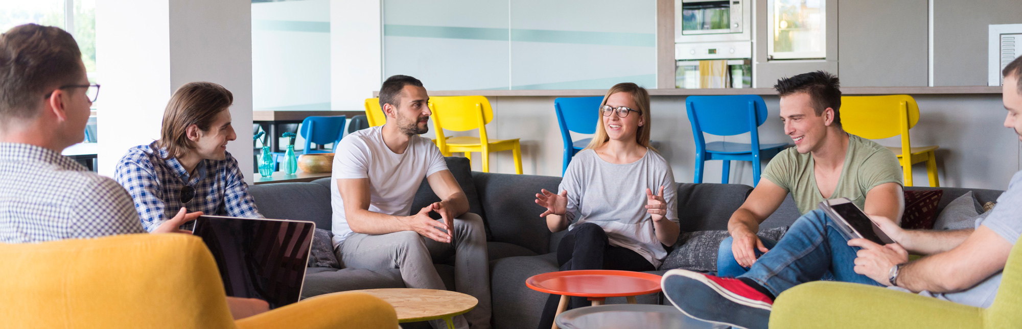 Six people sitting on couches having a discussion